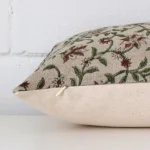 A floral cushion positioned on its back panel. The shot shows a lateral view of the designer fabric and its rectangle size.