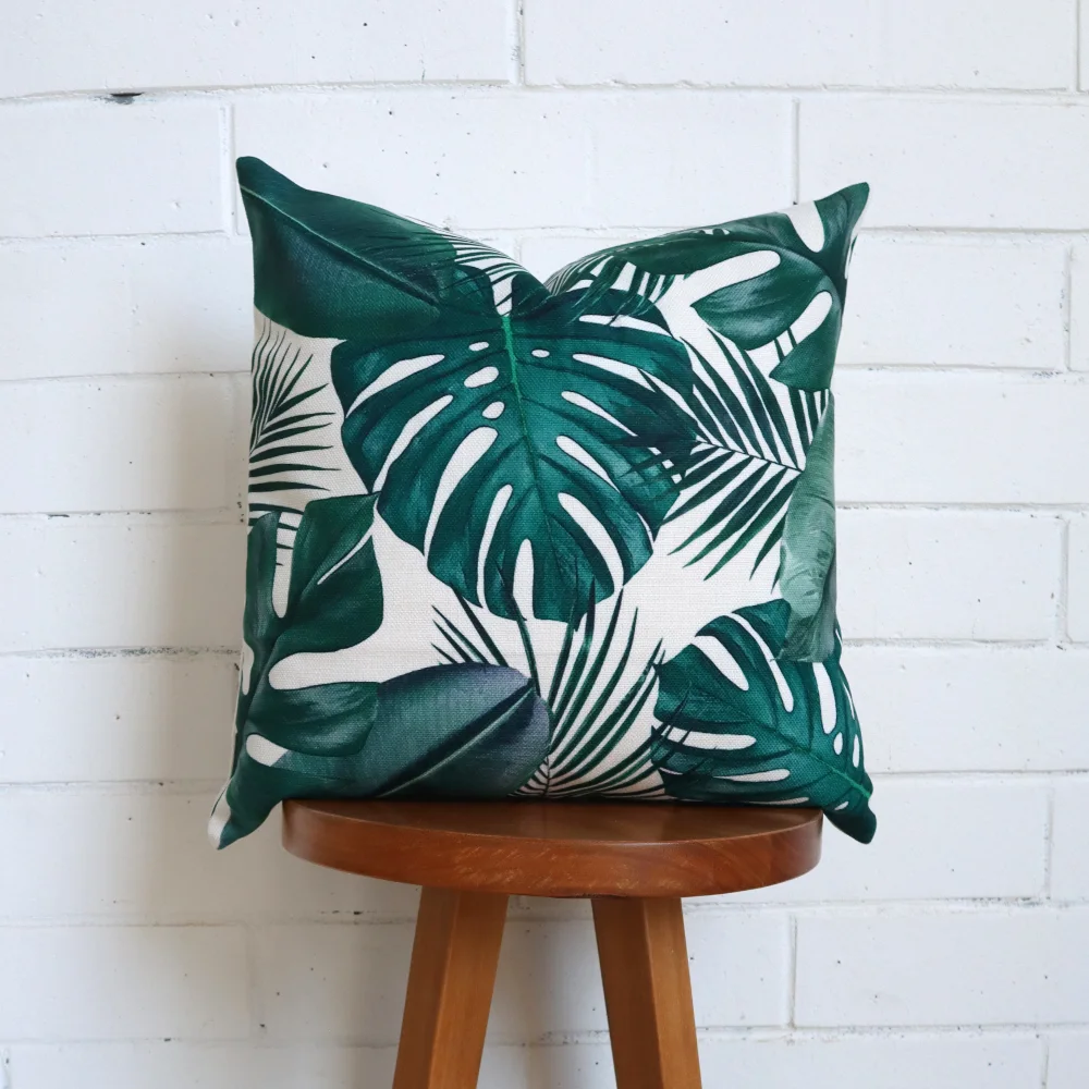 A tall stool with a tropical cushion placed on top of it.