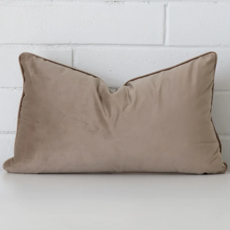 taupe-rectangular-velvet-cushion-cover-30cm-x-50cm-sc500-30c A lovely rectangle taupe cushion cover arranged in front of a white wall. It has a soft velvet material.