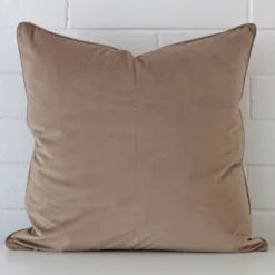 A stunning large velvet cushion in a taupe colour.