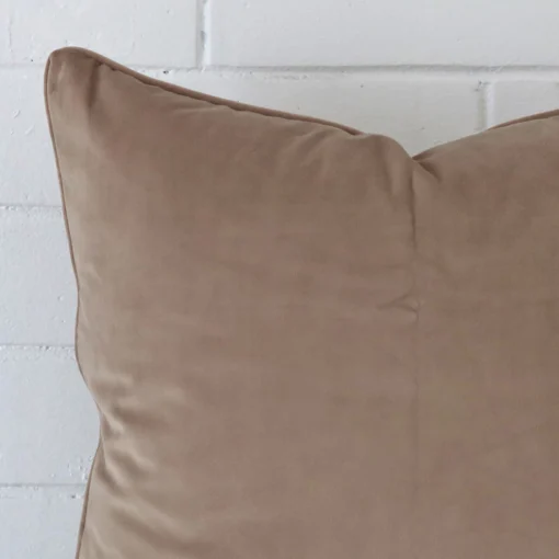 Enlarged shot of a large taupe cushion cover that highlights its velvet fabric.