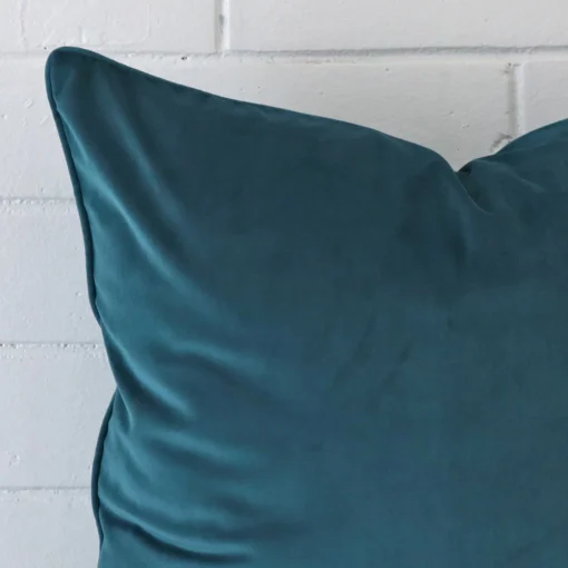 A magnified shot of a linen cushion cover in a large size and a teal colour.