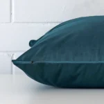 The seams of this velvet large cushion cover in teal are shown.