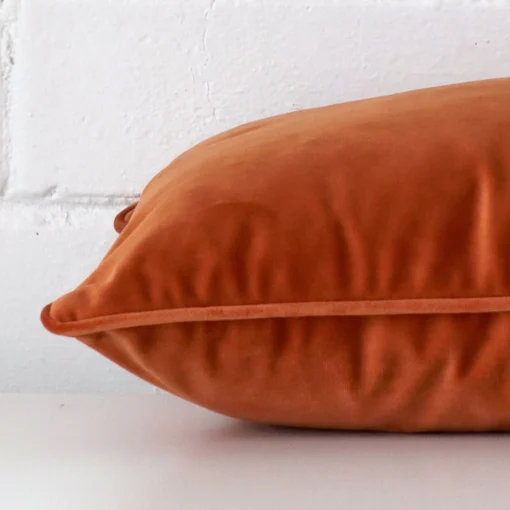 The seams of this velvet rectangle cushion cover in terracotta are shown. The image shows how the panels are attached.