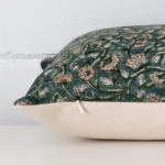 Rectangle floral cushion laying flat. The viewpoint highlights the seams of the designer fabric.