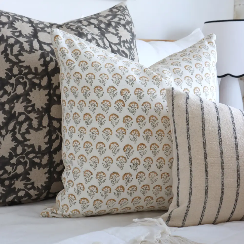 Three matching cushions shown close up.