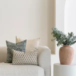 3 designer covers from the Vada set sitting on in the corner of a sofa.
