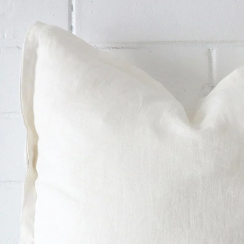 A zoomed view of this linen white cushion’s corner that shows a magnified view of its its large size.