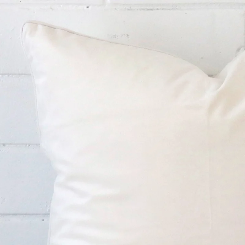 A close up shot showing the top left side of this large velvet cushion cover. The white tone is shown up close.