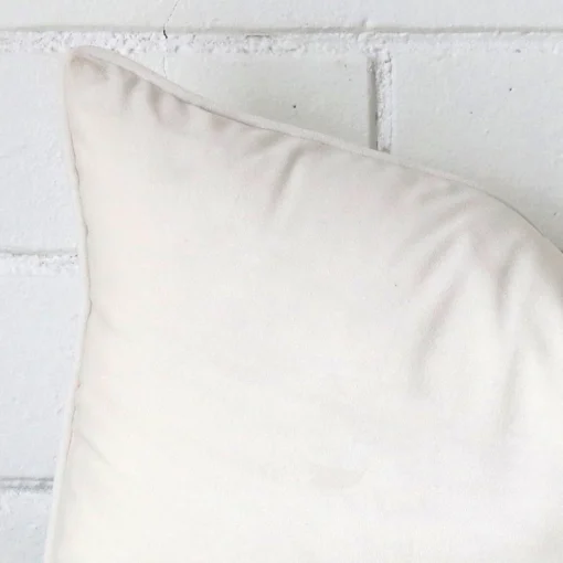 Enlarged shot of a rectangle white cushion cover that highlights the velvet fabric.