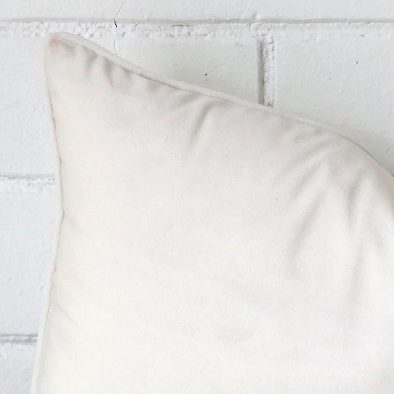 Enlarged shot of a rectangle white cushion cover that highlights the velvet fabric.