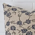 Zoomed photo of the top left corner of this floral cushion cover. The image clearly shows the designer material and large dimensions.